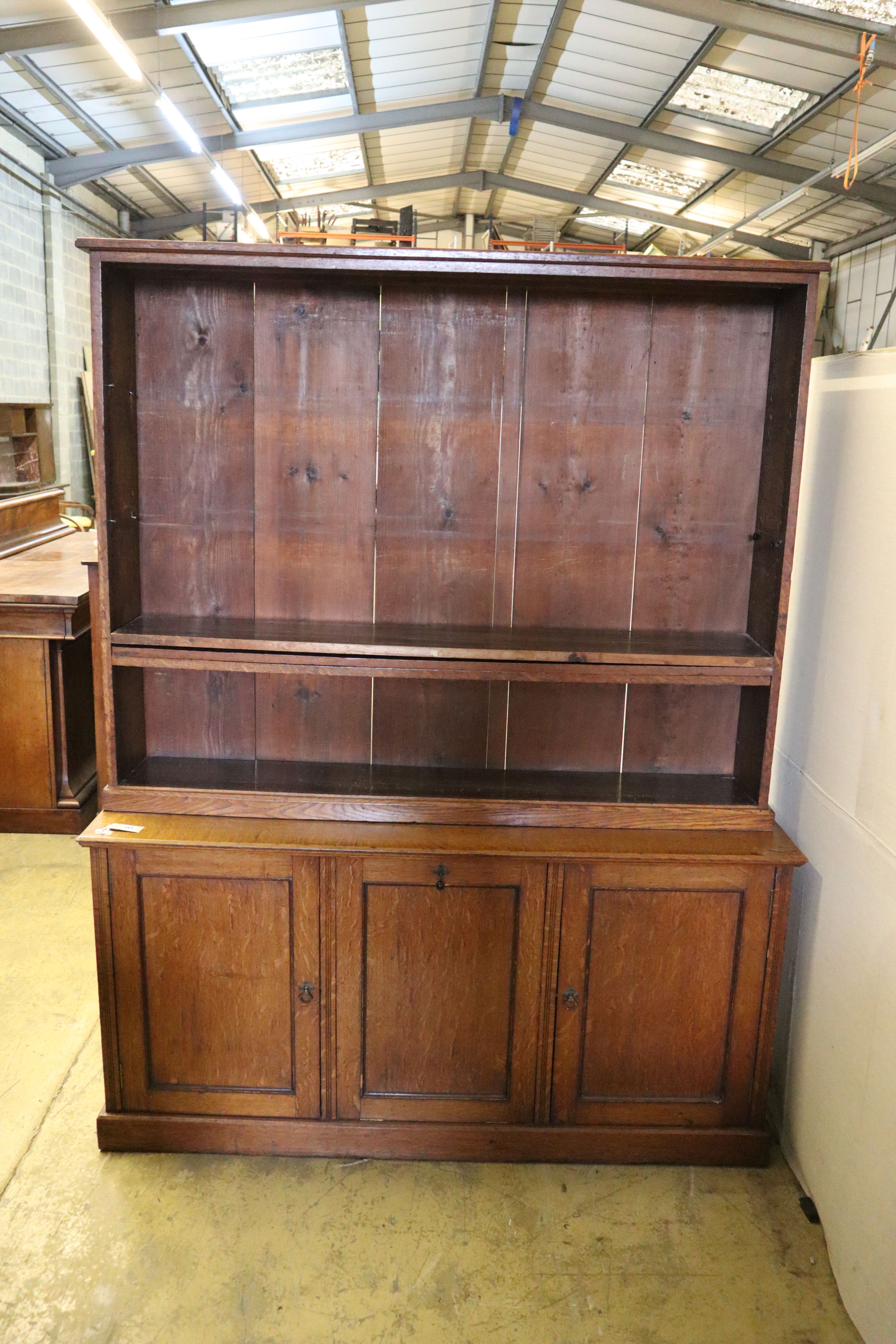 A Victorian oak bookcase cupboard, width 154cm, depth 43cm, height 168cm